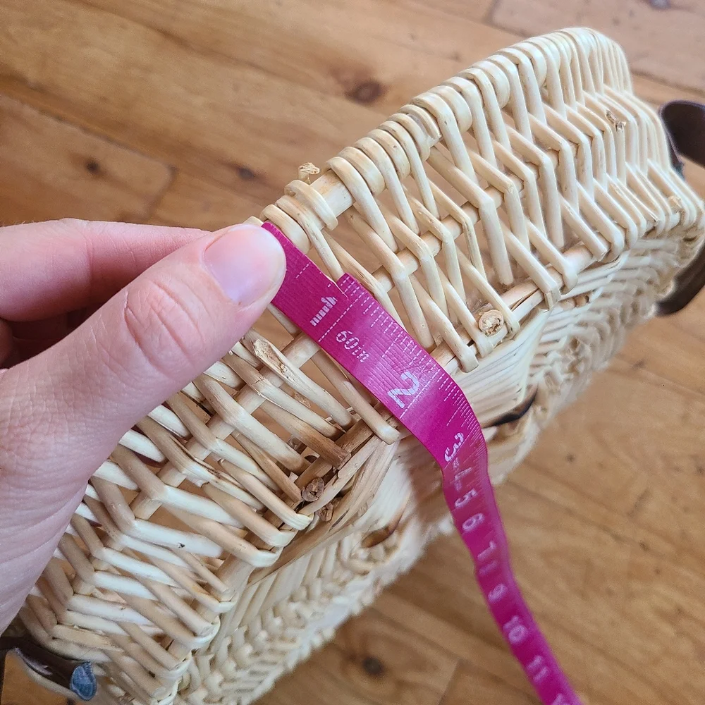 Woven wicker basket with faux leather handles